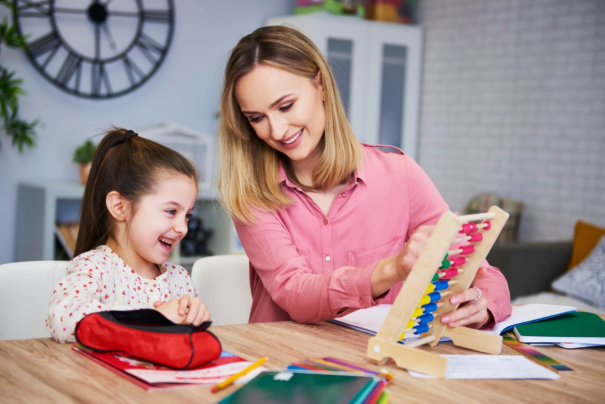 Young mother and child studying at home